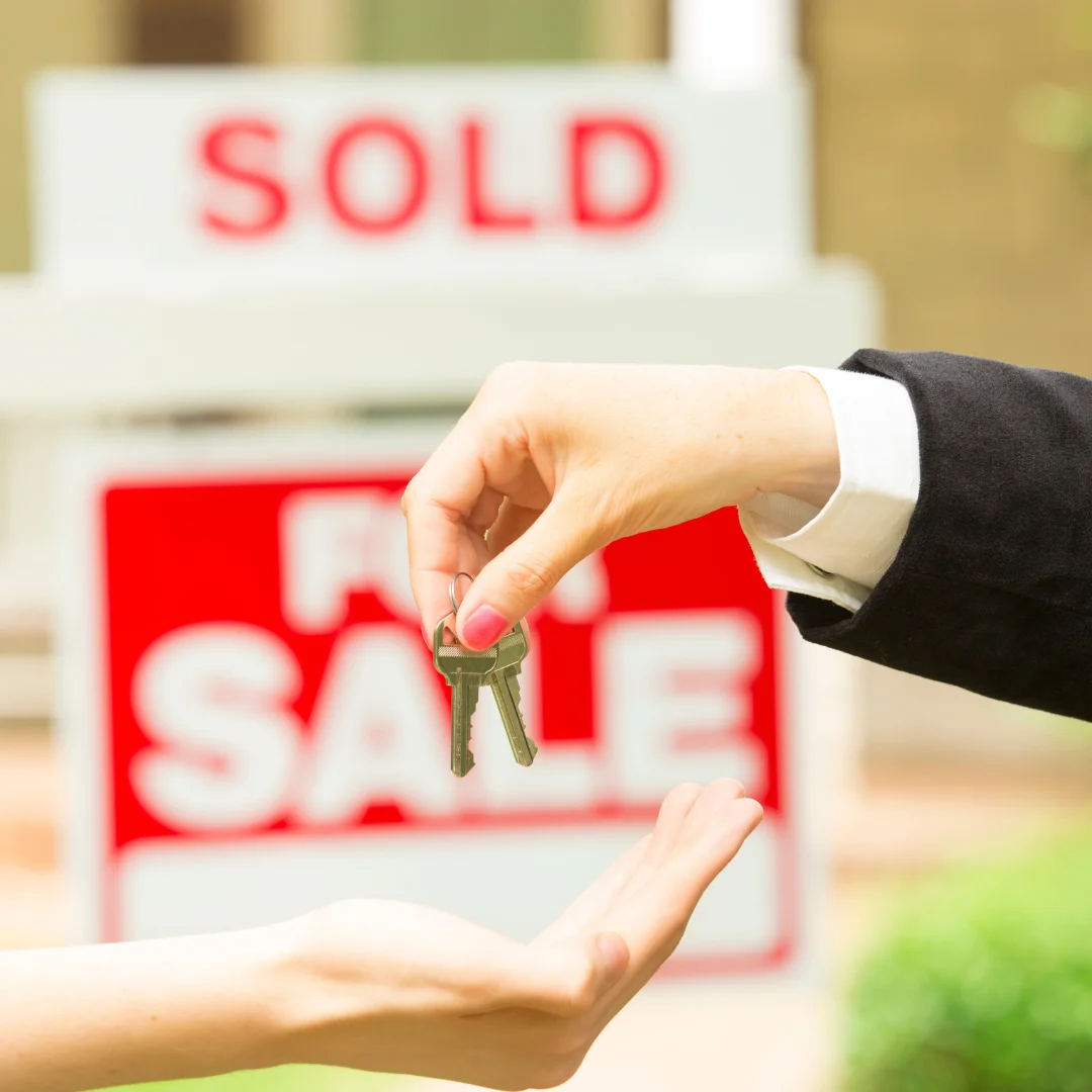 Real estate agent handing house keys